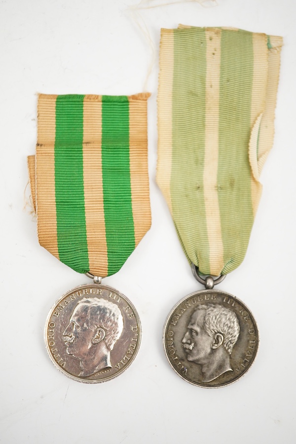 A cased Italy, Kingdom. Messina Earthquake Medal 1908, awarded to J. Stringer? (Worn), A.B. 18254 H.M.S. Bacchante, together with another uncashed example, unnamed, (2). Condition - fair.